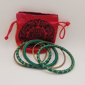 Green and gold silk thread bangles with red pouch